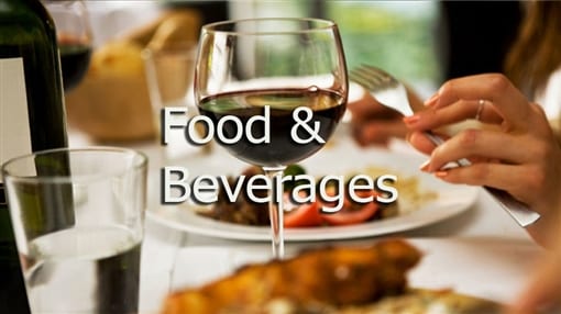 A glass of white wine beside a plated meal, with the words Food and Beverages